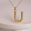 Polished 18K gold balloon letter U pendant necklace with a minimalist beaded design - Letter U