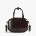 Dark brown glossy patent leather crossbody bag with rounded design and top handle - Brown
