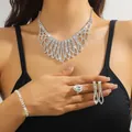 Luxurious silver bridal jewelry set with sparkling rhinestones worn by a model - Silver Fan Shaped Multi-Layer Mesh Necklace Bracelet Earrings Ring Set (PJ--T0244)