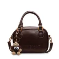 Retro brown leather handbag with adjustable strap and cute monster charm accessory - Brown