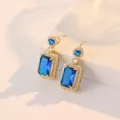 Deep blue rectangular zircon earrings with gold plating and white crystal halo - Earrings / Blue
