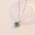 Elegant silver snowflake necklace with emerald green crystals and heart-shaped shadow - Emerald Snowflake Necklace