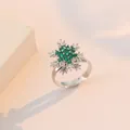 Elegant emerald green snowflake ring with silver setting on a minimalist backdrop - Emerald Snowflake Ring