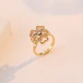 Eleganter goldener Drehring mit funkelnden Zirkonia-Blüten für einen stilvollen Damen-Look - Gold Herz Rotierender Ring