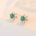 Silver snowflake stud earrings featuring vibrant green crystal center stones - Emerald Snowflake Earrings