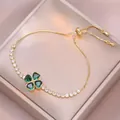 Golden clover bracelet with emerald heart stones and sparkling zircon pavé setting - Emerald Green Rotating Bracelet