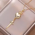 Golden heart and sword pendant necklace on champagne satin lining for elegant jewelry style - Heart Cross Sword Style / Gold