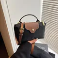 Mini handbag in black nylon and brown leather contrast with gold-tone hardware - Black