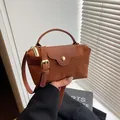 Brown nylon crossbody bag with leather texture flap and adjustable shoulder strap - Caramel color