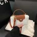White nylon and brown leather mini crossbody bag with golden hardware in a black gift box - White