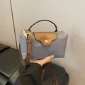 Women's grey nylon crossbody bag with brown leather flap and top handles - Gray