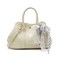 Chic cream white PU leather tote with lace bow charm and crossbody strap on white background - With Pendant / Yellow