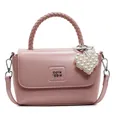 Pale pink leather handbag with woven handle, pearl heart charm, and crossbody strap - With Pendant / Pink