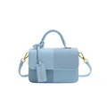 Light blue faux leather handbag with textured patchwork panels and golden metal hardware - Blue