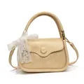 Beige faux leather handbag with crinkled texture and large white lace bow detail - Yellow
