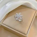 Close-up of sparkling snowflake ring with zircons on a champagne jewelry box - Rotating Snowflake Ring (J0240) / Silver
