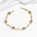 Detail of gold flower bracelet with purple zircon stones and sparkling white crystals - Purple Round Stone (TS0383) / Purple Bracelet (TS0383)