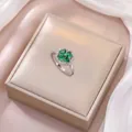 Detailed macro of a silver ring featuring heart-shaped emerald-green clover zircon stones - J0316 Steel Ring