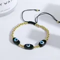 Detail of adjustable evil eye bracelet featuring gold beads and handcrafted woven black cord - Black
