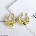 18K gold plated hoop earrings featuring yellow evil eye enamel charms on white background - Yellow