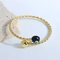 Detail of 18K gold plated twisted rope cuff bracelet with black enamel evil eye charm - Black