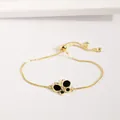 Détails du bracelet papillon doré avec de l'émail noir et des zircons scintillants - Noir