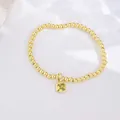 Close-up of 18k gold plated beaded bracelet with square yellow zircon pendant - November (Citrine Zirconia)