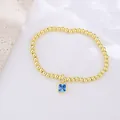 Close-up of 18k gold-plated beaded bracelet featuring a square blue zircon pendant charm - December (Blue Zirconia)