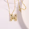 Gold-plated letter M pendant necklace featuring sparkling zircon inlay and bead chain - Letter M
