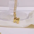 Detailed close-up of 18K gold-plated puffed letter M pendant with shimmering pavé stones - Letter M