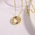Gold plated alphabet necklace featuring oval pendant with inlaid cubic zirconia crystals - Letter O