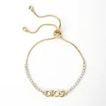 Detail view of the DIOS letter plate on an adjustable 18K gold plated zircon bracelet - DIOS Letter Tennis Chain Style (E)