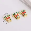 Close-up of gold Christmas candy cane charms with red bows and enamel detailing - Candy Cane Style (03)
