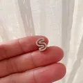 Gold plated alphabet letter S charm with cubic zirconia pave setting on fingertip - Letter S