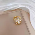 Close-up of golden clover ring with sparkling marquise-cut zircon stones and micro-pave - Four-leaf Open Ring (J0007) / Gold Ring