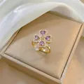 Detail of a clover ring with purple heart-shaped zircons on a champagne jewelry box - Ring / Purple Ring