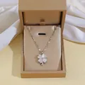 Detail of four-leaf clover opal necklace inside an elegant gold jewelry gift box - Rotating Opal Necklace (X0129)