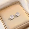 Detail view of rotating cat eye stone flower stud earrings with elegant silver stem - Rotating Opal Earrings (E0116)