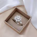 Macro shot of silver floral ring with square zircon stone in a luxury jewelry box - Ring (J0082) / Steel