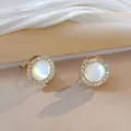 Macro detail of gold stud earrings with mother of pearl inlay and sparkling zircon halo - Gold Tone Cat's Eye Earrings (E0006)