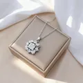 Macro shot of silver flower pendant with cubic zirconia on champagne jewelry box - Necklace (X1191) / Steel