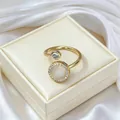 Macro detail of adjustable gold ring with rotating cat eye stone and pavé crystal trim - Gold Tone Ring (J0008)