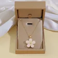 Detail of flower necklace with pink petals in a golden premium jewelry gift box - White Daisy Clavicle Necklace