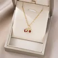 Detailed shot of gold cherry pendant with red heart crystals in a velvet jewelry box - Ruby Red Heart Double Cherry (X4550)