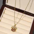Detailed view of cherry pendant necklace with red cubic zirconia and gold leaves - Red Heart Cherry Style (X2606)