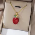 Golden titanium necklace featuring a glossy red apple pendant with green zircon leaf - Red Apple Shape Design (X2711)