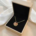 Detail of clover necklace with amber heart zircons in a golden jewelry box - Heart Clover Style (X1511) / Orange