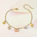 Detailed view of gold anklet featuring heart, butterfly, and bird charms with crystals - Five Pendant Style (TL0003)