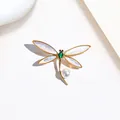Detail of dragonfly brooch with golden wings, green gemstone and white pearl - Gold Shell Green Gem Dragonfly Style (XX0021)