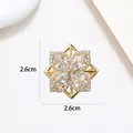 Macro view of 2.6cm snowflake brooch with sparkling cubic zirconia on gold base - Xx0141